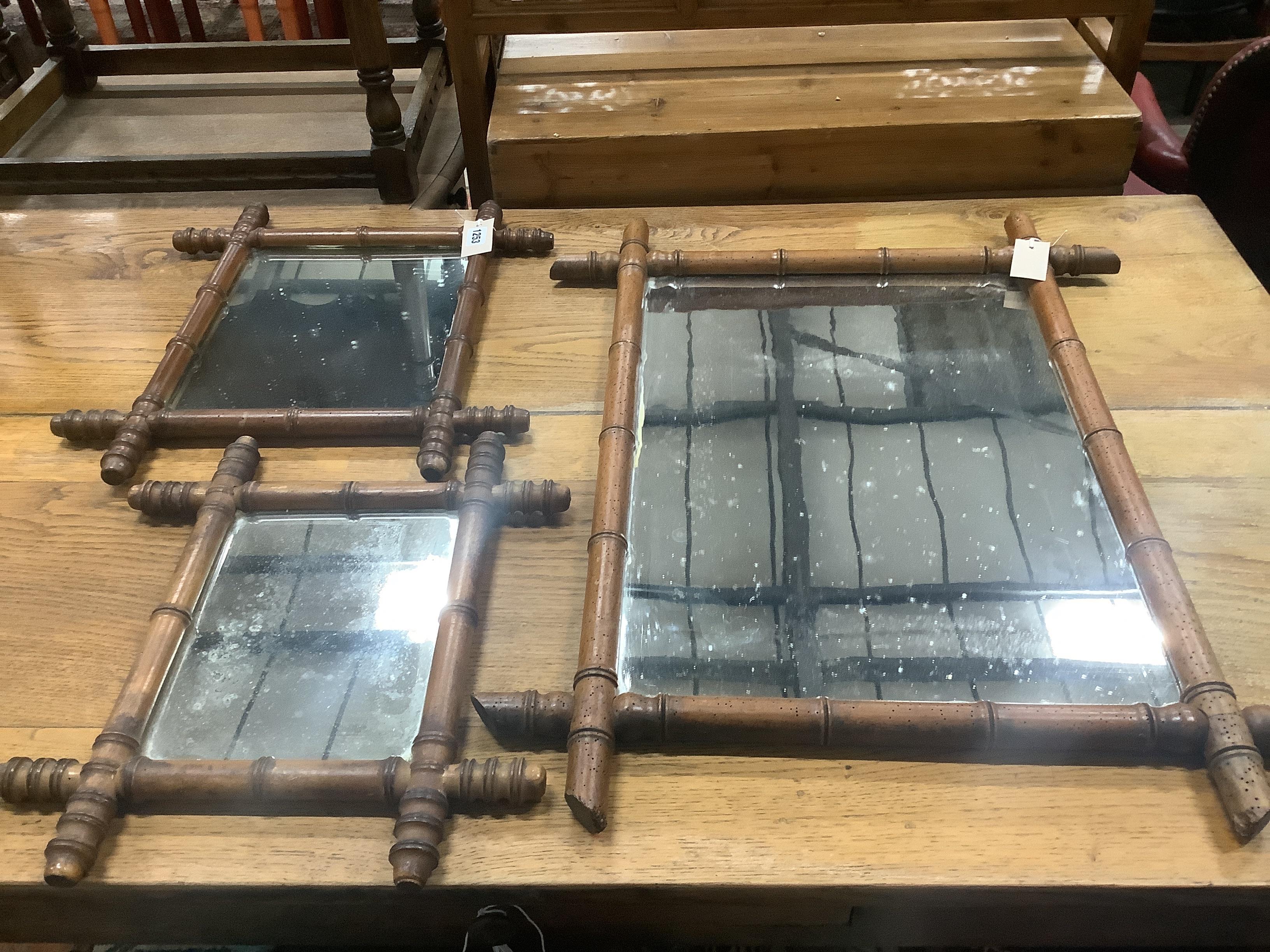 Two Edwardian bamboo moulded beech wall mirrors, largest 50 x 44cm and another larger example with worm damage